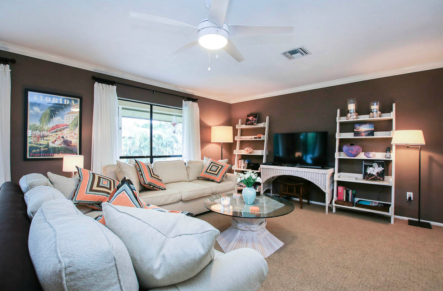 Living room at Blind Pass F203 with vintage Florida art
