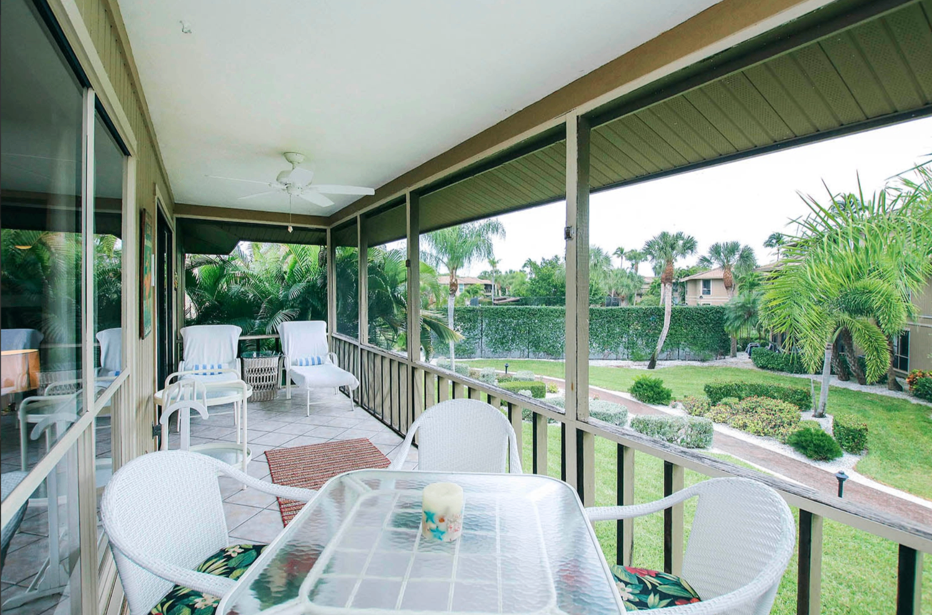Screened lanai at Blind Pass F203 overlooking tropical gardens